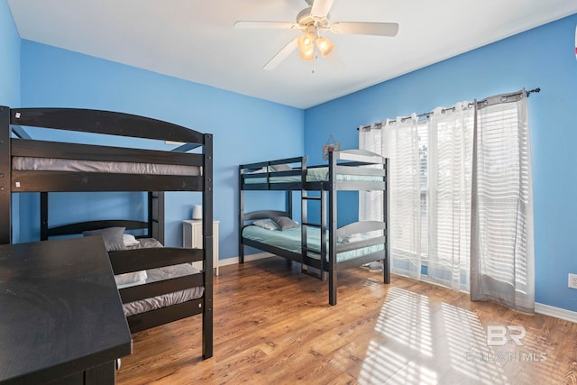 bedroom with ceiling fan and wood-type flooring