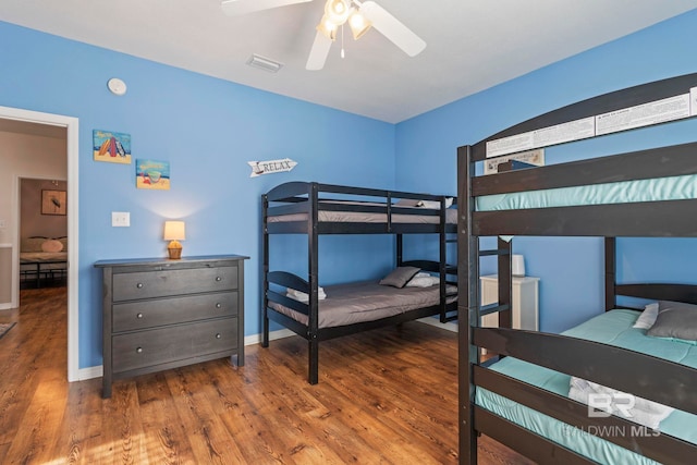 bedroom with wood-type flooring and ceiling fan