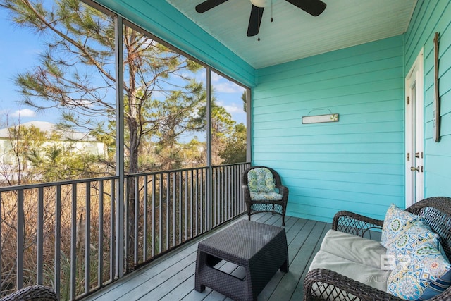 sunroom / solarium featuring ceiling fan