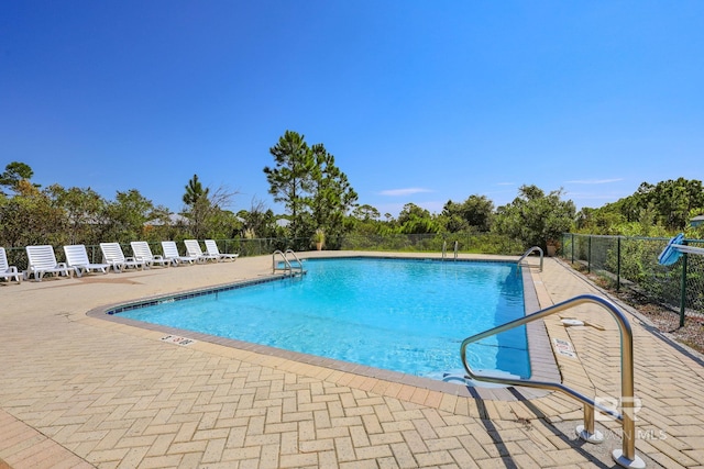 view of swimming pool with a patio