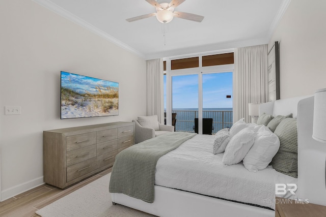 bedroom featuring baseboards, light wood-style floors, ornamental molding, and access to outside