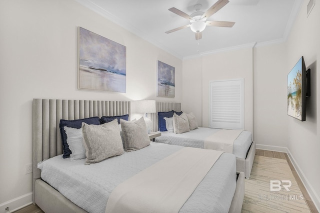 bedroom with baseboards, wood finished floors, and crown molding