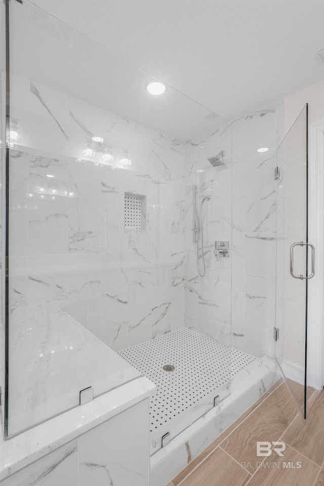 bathroom with a marble finish shower