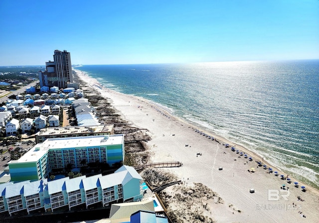 drone / aerial view featuring a water view and a beach view