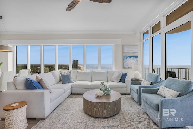 living area featuring crown molding, light wood finished floors, and ceiling fan