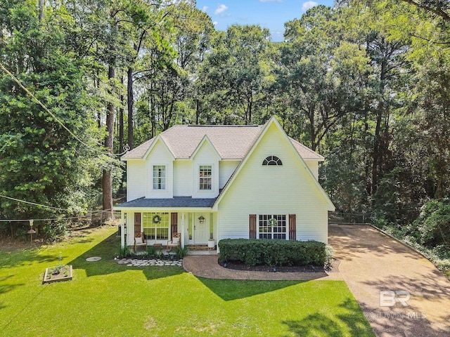 106 Gordon Cir, Daphne, AL 36526 - traditional-style house with a porch, concrete driveway, a front lawn, view of wooded area, and a shingled roof