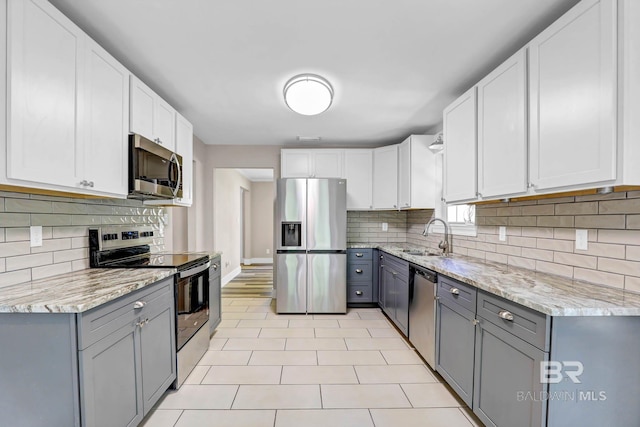 106 Gordon Cir, Daphne, AL 36526 - kitchen featuring stainless steel appliances, gray cabinets, and light stone countertops