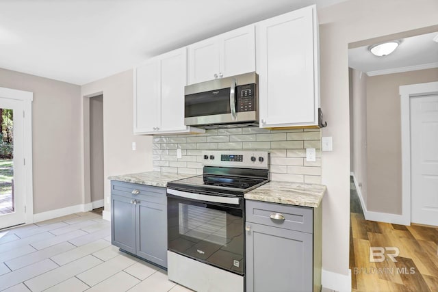 106 Gordon Cir, Daphne, AL 36526 - kitchen featuring range with electric cooktop, stainless steel microwave, gray cabinetry, tasteful backsplash, and white cabinets