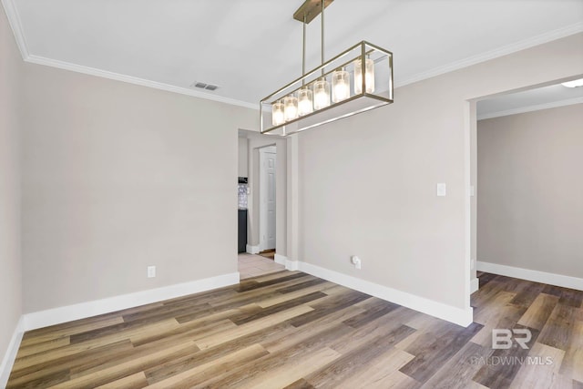 106 Gordon Cir, Daphne, AL 36526 - unfurnished dining area featuring wood finished floors, ornamental molding, and a chandelier