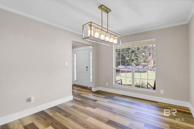 106 Gordon Cir, Daphne, AL 36526 - unfurnished dining area featuring wood finished floors, ornamental molding, and a chandelier