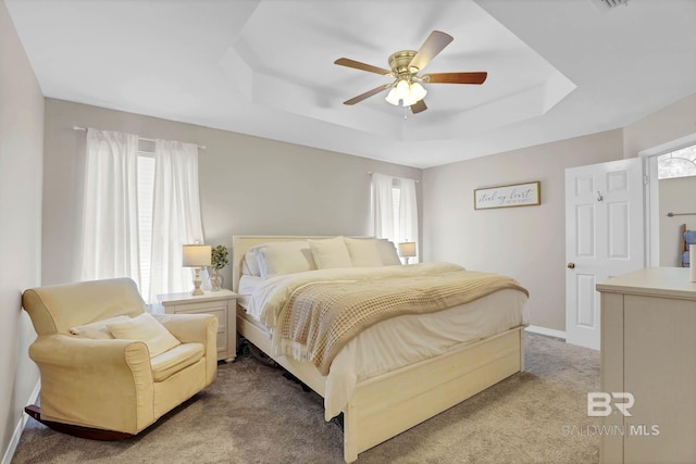 106 Gordon Cir, Daphne, AL 36526 - carpeted bedroom featuring a tray ceiling, multiple windows, and a ceiling fan