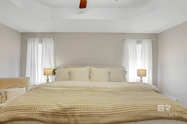 106 Gordon Cir, Daphne, AL 36526 - bedroom with multiple windows, a ceiling fan, and a tray ceiling