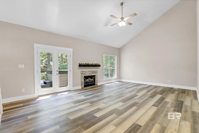 106 Gordon Cir, Daphne, AL 36526 - unfurnished living room featuring healthy amount of natural light, a ceiling fan, high vaulted ceiling, wood finished floors, and a tiled fireplace
