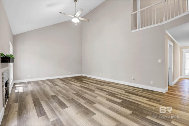 106 Gordon Cir, Daphne, AL 36526 - unfurnished living room featuring high vaulted ceiling, a ceiling fan, wood finished floors, and a fireplace