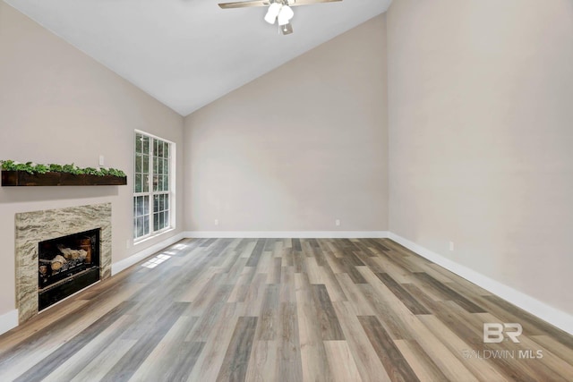 106 Gordon Cir, Daphne, AL 36526 - unfurnished living room with wood finished floors, high vaulted ceiling, a ceiling fan, and a fireplace