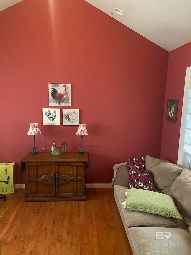 living room with hardwood / wood-style flooring and lofted ceiling