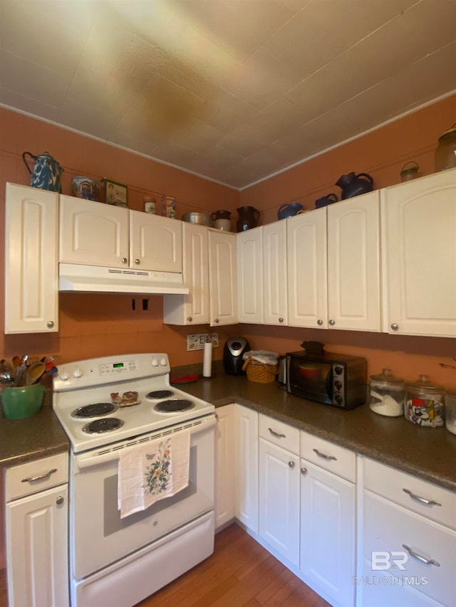 kitchen featuring white electric stove, white cabinets, and hardwood / wood-style floors