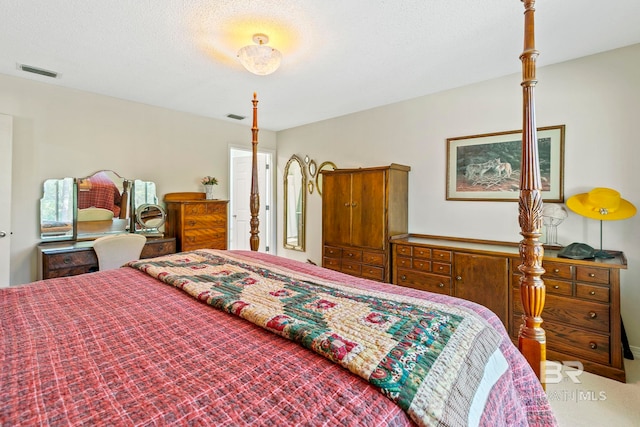 bedroom featuring carpet flooring and a textured ceiling