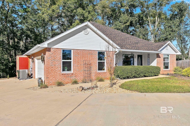 view of front facade featuring a garage and central AC