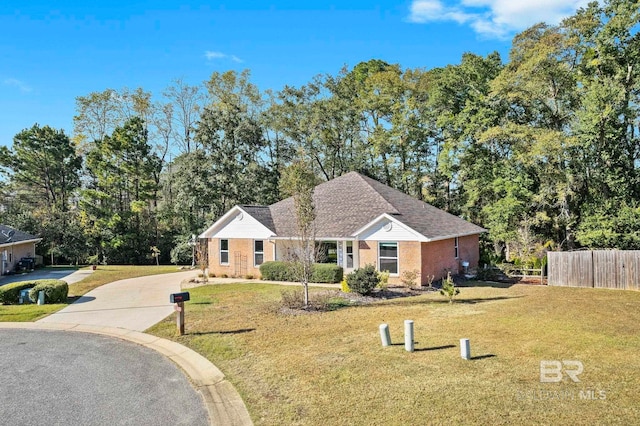 single story home featuring a front lawn