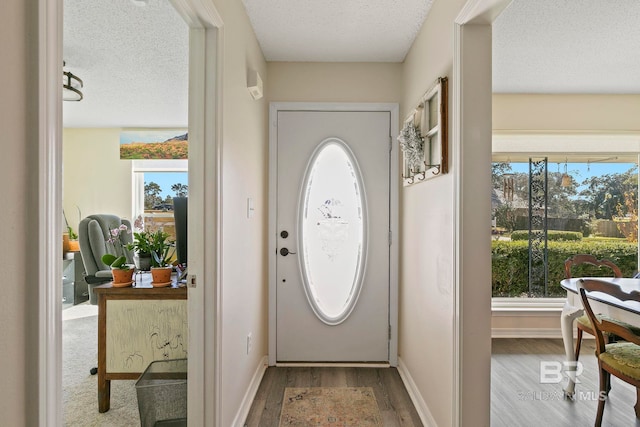 entryway featuring a textured ceiling and light wood-type flooring