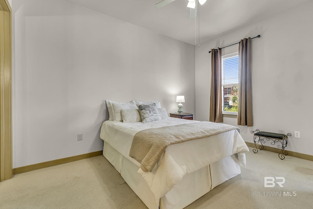 bedroom with a ceiling fan, light colored carpet, and baseboards