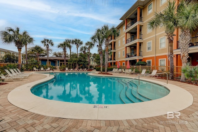 view of pool featuring a patio area and fence