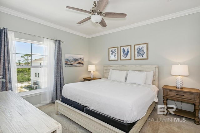 carpeted bedroom featuring crown molding and ceiling fan