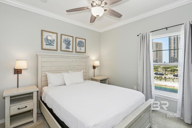 carpeted bedroom featuring ceiling fan and ornamental molding