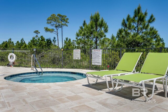 view of swimming pool with a community hot tub and a patio