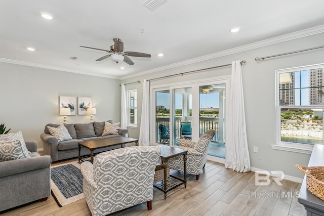 living room with ceiling fan, ornamental molding, and light hardwood / wood-style flooring