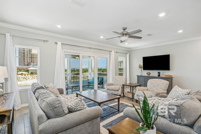 living room with crown molding, hardwood / wood-style flooring, and ceiling fan