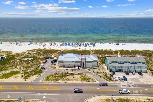 bird's eye view featuring a water view and a beach view