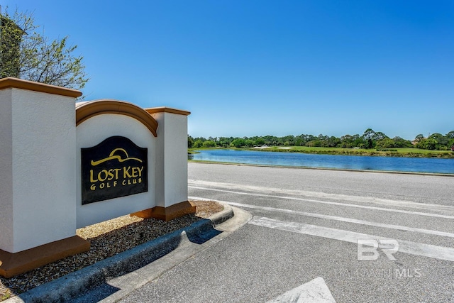 community sign with a water view