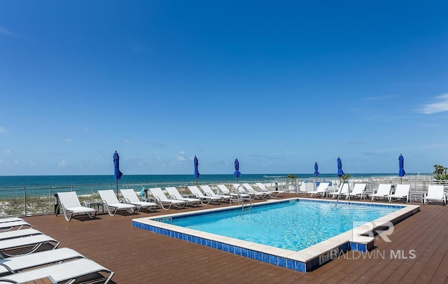 view of swimming pool with a water view