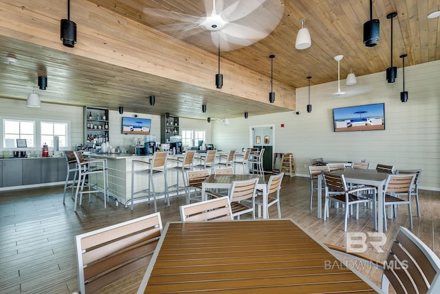 dining area featuring ceiling fan, hardwood / wood-style flooring, and wood ceiling