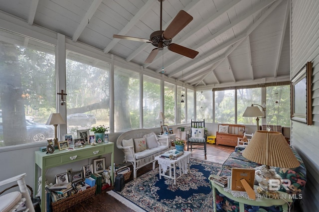 sunroom / solarium with ceiling fan and lofted ceiling with beams