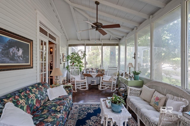 sunroom / solarium with a healthy amount of sunlight, ceiling fan, and vaulted ceiling with beams