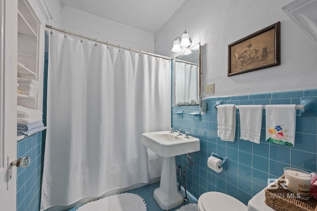 bathroom featuring a shower with shower curtain, tile walls, toilet, and tile patterned flooring