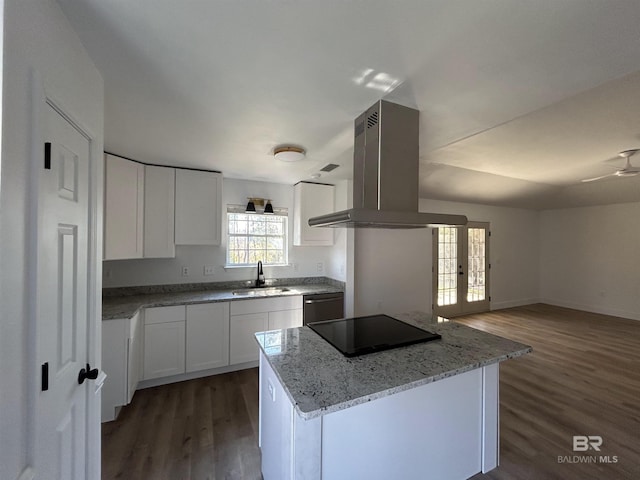 kitchen featuring white cabinetry, sink, island exhaust hood, a center island, and black appliances