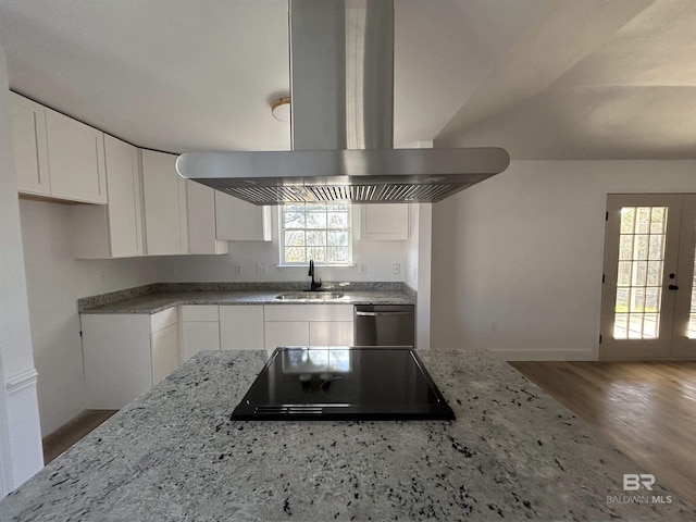 kitchen featuring island range hood, white cabinetry, dishwasher, sink, and black electric cooktop