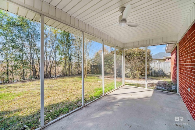 unfurnished sunroom featuring ceiling fan