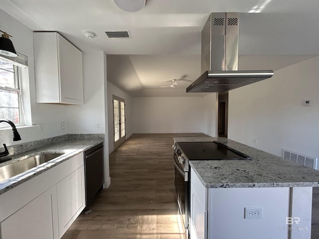 kitchen with black dishwasher, light stone counters, island range hood, white cabinets, and stainless steel electric range oven