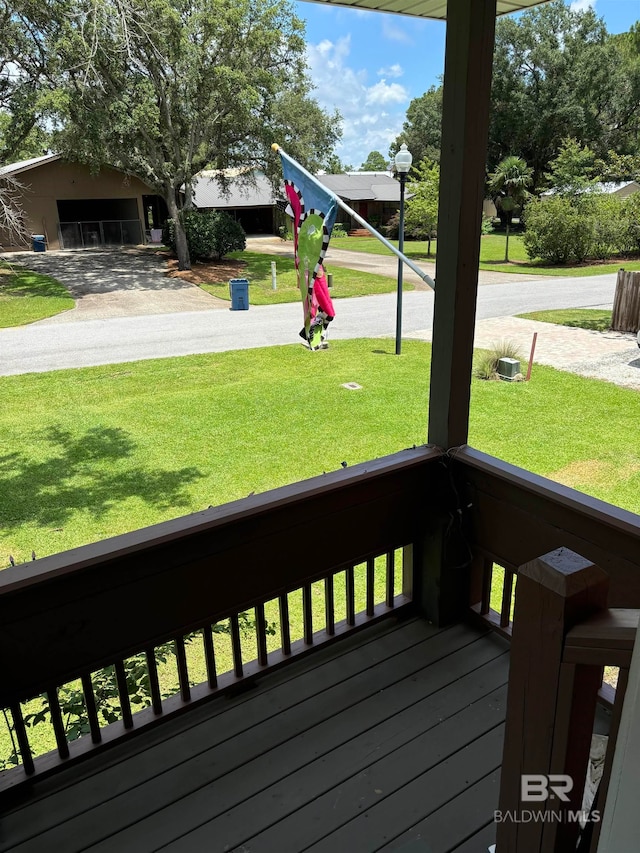 wooden deck with a lawn