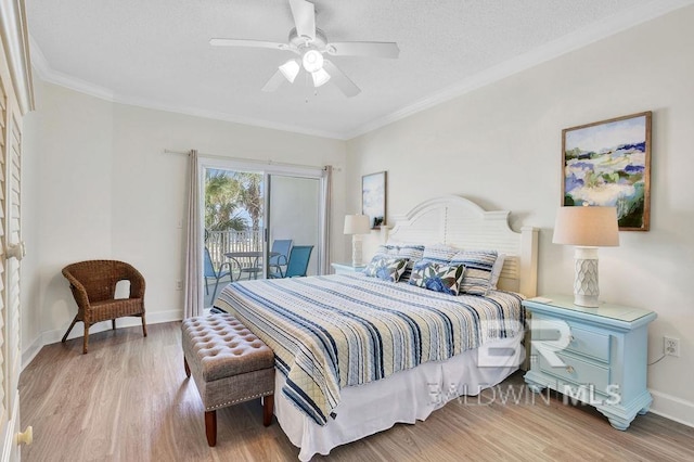 bedroom with baseboards, ornamental molding, wood finished floors, and access to exterior