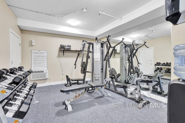 exercise room with a textured ceiling