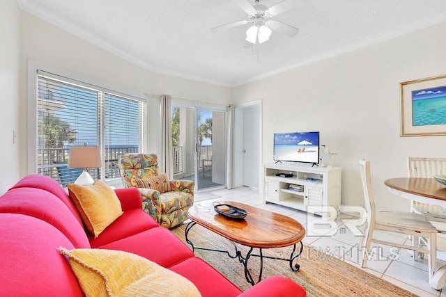 living room with light tile patterned floors, baseboards, ornamental molding, and a ceiling fan