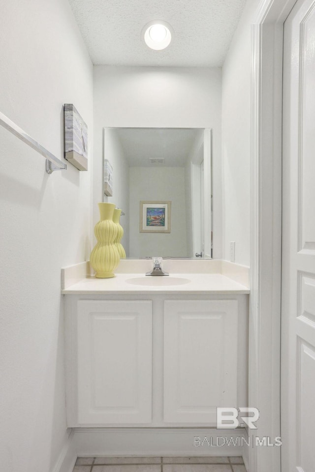 bathroom with vanity, tile patterned flooring, and a textured ceiling