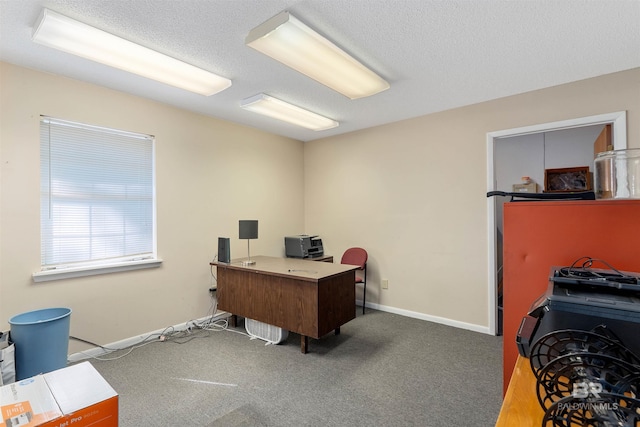 carpeted office space featuring a textured ceiling