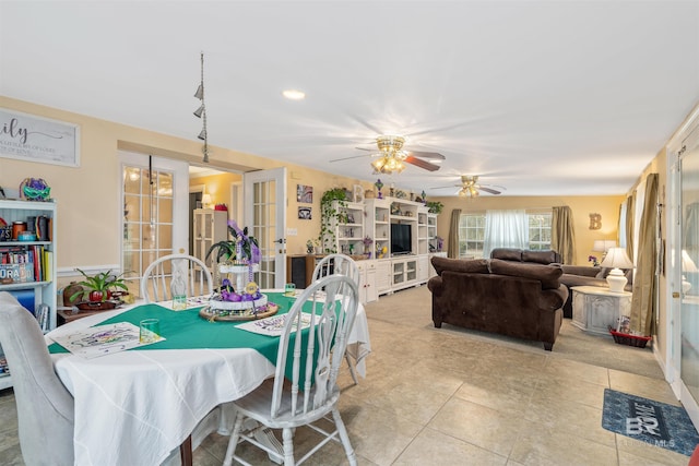 dining space with light tile floors, french doors, and ceiling fan